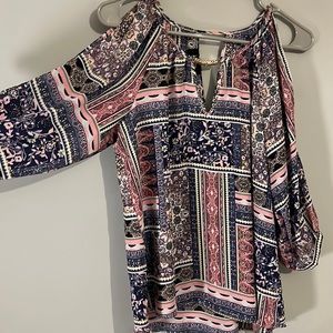 Open shoulder, business casual, multi colored, multi patterned top.